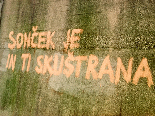 Archive photograph of the graffiti 'Soncek je in ti skuštrana' (The sun is shining and your hair is in a mess). Author of the photograph: Maja Sever.